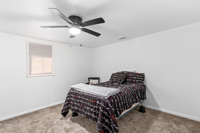 carpeted bedroom with baseboards and ceiling fan