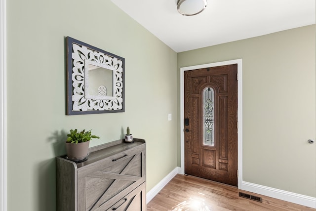 foyer featuring baseboards and light wood-style floors
