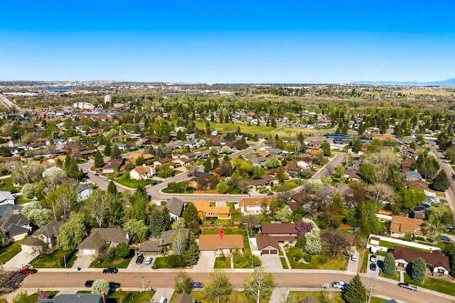 aerial view of property and surrounding area with nearby suburban area