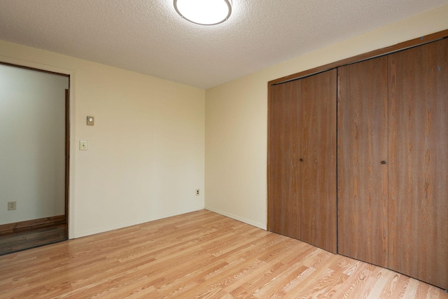 4 Rocky Mountain Dr, Whitehall, MT 59759 - unfurnished bedroom featuring light wood-type flooring, a closet, and a textured ceiling