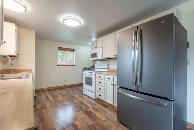 4 Rocky Mountain Dr, Whitehall, MT 59759 - kitchen with white appliances, a sink, dark wood-style flooring, and white cabinetry