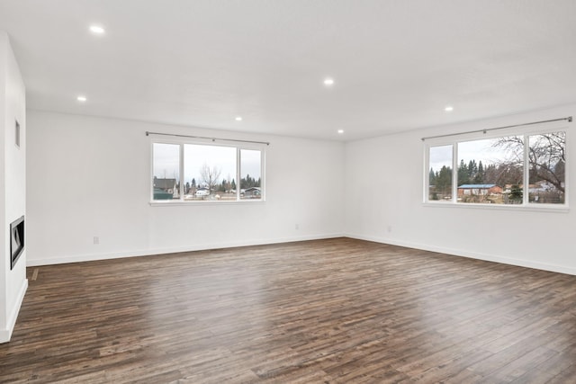 135 Meadow Ln, Victor, MT 59875 - unfurnished room with plenty of natural light, dark wood-style floors, recessed lighting, baseboards, and a fireplace
