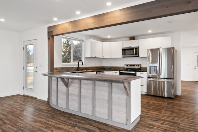135 Meadow Ln, Victor, MT 59875 - kitchen with stainless steel appliances, a sink, dark countertops, recessed lighting, and dark wood-style floors