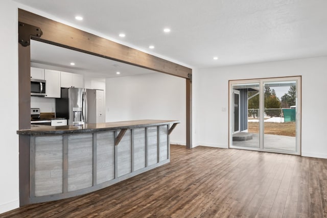 135 Meadow Ln, Victor, MT 59875 - kitchen with stainless steel appliances, white cabinets, recessed lighting, dark wood-style floors, and baseboards