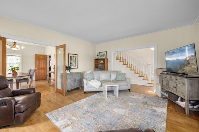 211 Idaho Ave, Whitefish, MT 59937 - living area featuring a chandelier, light wood-type flooring, and stairs