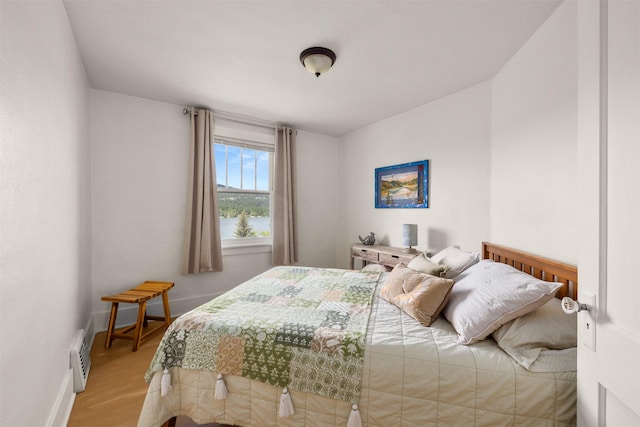 211 Idaho Ave, Whitefish, MT 59937 - bedroom featuring light wood-style flooring, a water view, and baseboards