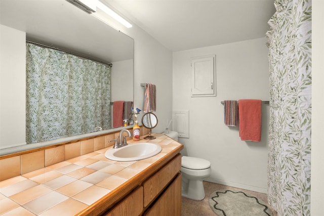 211 Idaho Ave, Whitefish, MT 59937 - full bath featuring toilet, vanity, baseboards, and tile patterned flooring