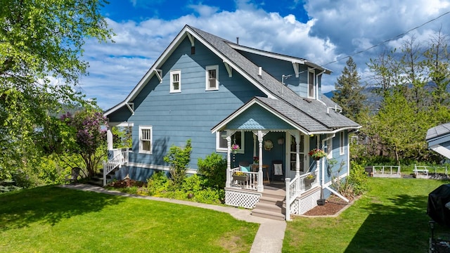 211 Idaho Ave, Whitefish, MT 59937 - view of front of home featuring covered porch, a front yard, and a shingled roof