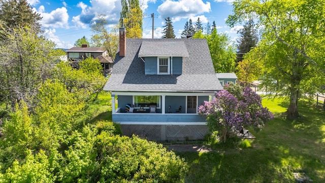 211 Idaho Ave, Whitefish, MT 59937 - view of side of home with a shingled roof, a yard, and a chimney