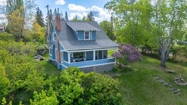 211 Idaho Ave, Whitefish, MT 59937 - rear view of house featuring roof with shingles, a chimney, and a yard