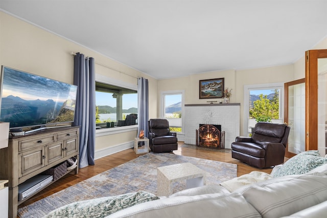 211 Idaho Ave, Whitefish, MT 59937 - living area with a brick fireplace, wood finished floors, and baseboards
