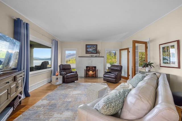 211 Idaho Ave, Whitefish, MT 59937 - living room with a brick fireplace, wood finished floors, and baseboards