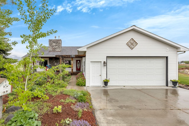 551 Fox Meadow Ln, Hamilton, MT 59840 - single story home with a garage, concrete driveway, and a chimney