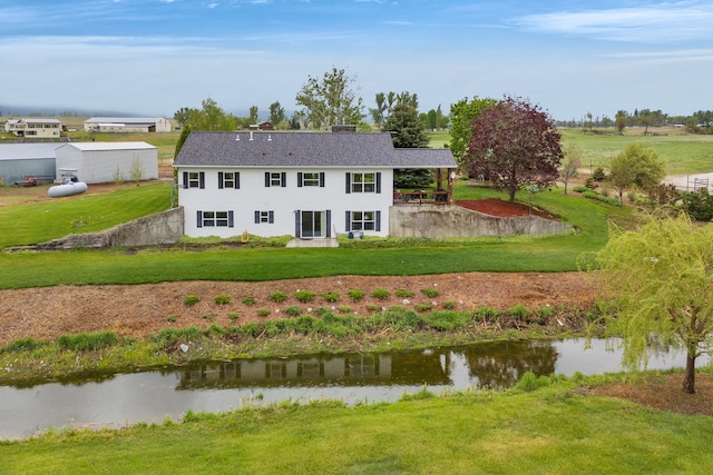 551 Fox Meadow Ln, Hamilton, MT 59840 - back of house with a yard, a chimney, and a water view