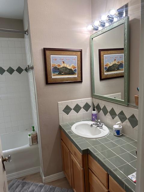 339 E Beckwith Ave, Missoula, MT 59801 - full bathroom with vanity, shower / bath combination, and backsplash