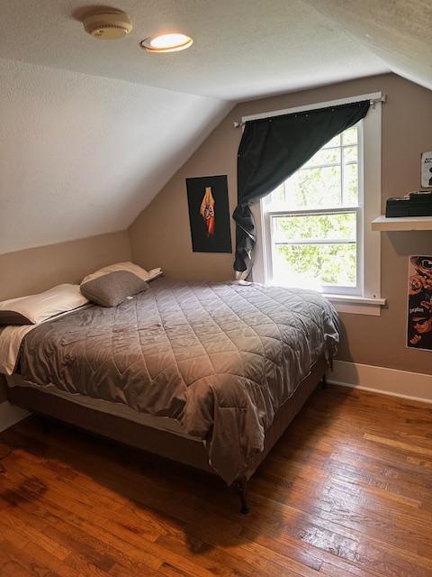 339 E Beckwith Ave, Missoula, MT 59801 - bedroom with lofted ceiling, wood finished floors, and baseboards