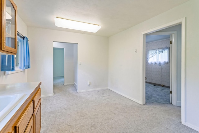 10225 Shady Ln, Bonner, MT 59823 - empty room with light carpet, a sink, and baseboards
