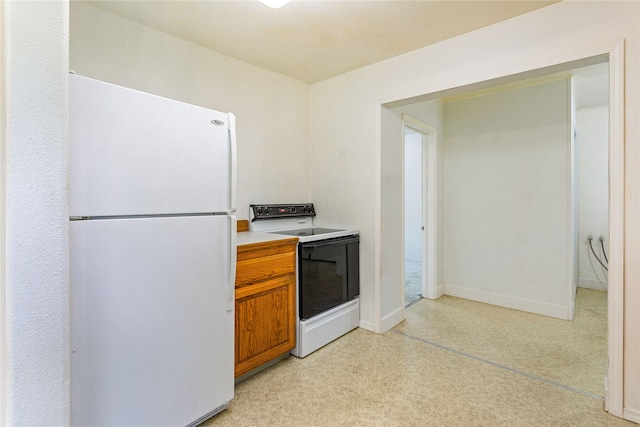 10225 Shady Ln, Bonner, MT 59823 - kitchen with white appliances, brown cabinets, light countertops, and baseboards