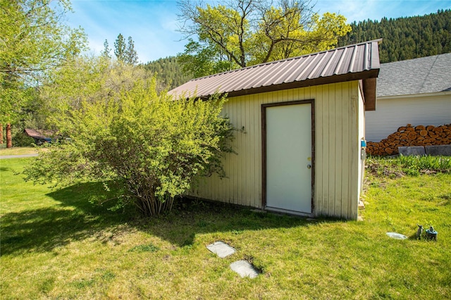 10225 Shady Ln, Bonner, MT 59823 - view of shed featuring a wooded view