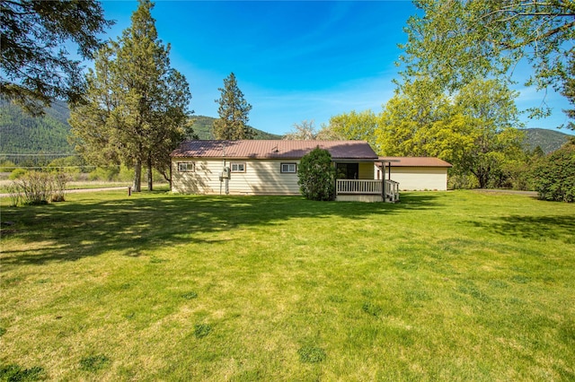 10225 Shady Ln, Bonner, MT 59823 - rear view of house featuring a lawn and metal roof