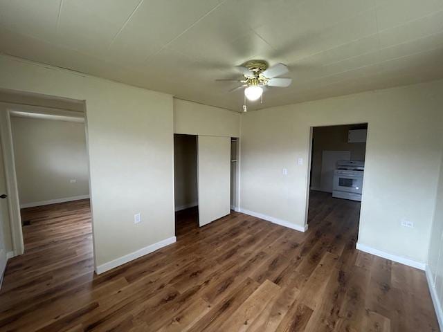 2001 Utah Ave, Butte, MT 59701 - unfurnished bedroom featuring dark wood-style flooring, a closet, baseboards, and ceiling fan