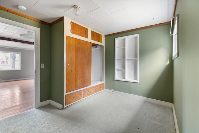 unfurnished bedroom featuring carpet, baseboards, and a closet