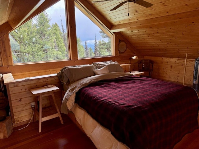 bedroom featuring hardwood / wood-style flooring, wood walls, vaulted ceiling, wood ceiling, and a ceiling fan