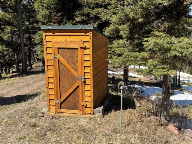 view of shed featuring a forest view