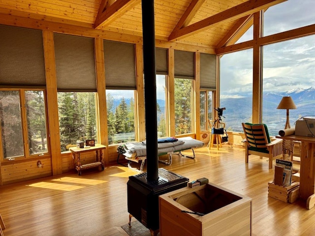 sunroom / solarium with wood finished floors, wooden ceiling, and a deck