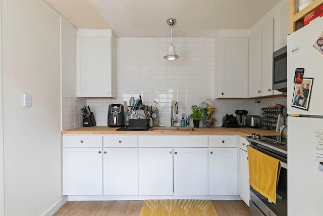 2112 W Central Ave, Missoula, MT 59801 - kitchen with appliances with stainless steel finishes, a sink, and white cabinetry