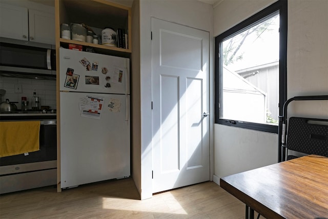 2112 W Central Ave, Missoula, MT 59801 - kitchen featuring stainless steel appliances, light wood-type flooring, and backsplash
