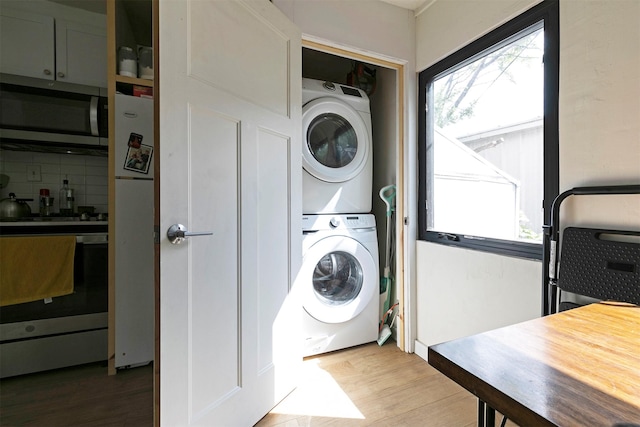 2112 W Central Ave, Missoula, MT 59801 - laundry room featuring stacked washing machine and dryer and light wood finished floors