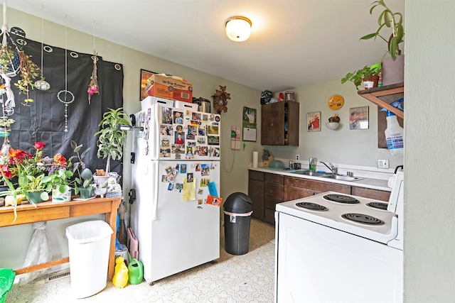 2112 W Central Ave, Missoula, MT 59801 - kitchen featuring white appliances, a sink, dark brown cabinetry, light countertops, and light flooring