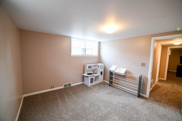 carpeted empty room with baseboards