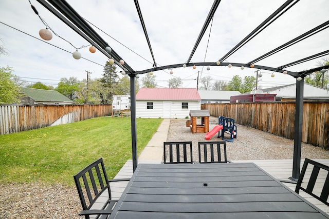 wooden terrace featuring an outdoor structure
