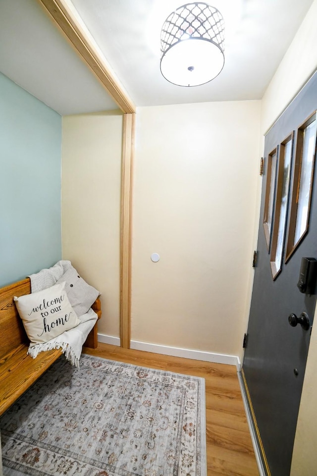 foyer entrance featuring light wood-type flooring and baseboards