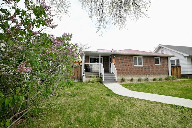 view of front facade featuring brick siding and a porch