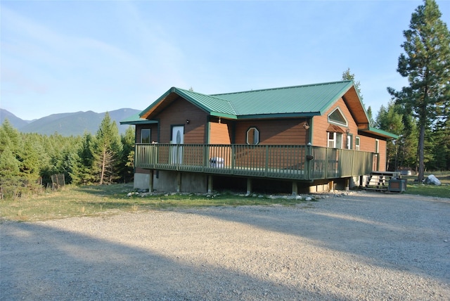 174 Badger Trl, Eureka, MT 59917 - rustic home featuring metal roof and a deck with mountain view