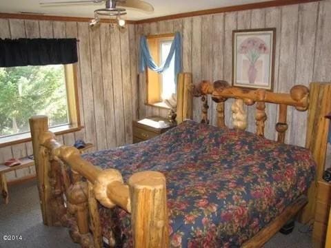 174 Badger Trl, Eureka, MT 59917 - bedroom with wood walls and carpet floors