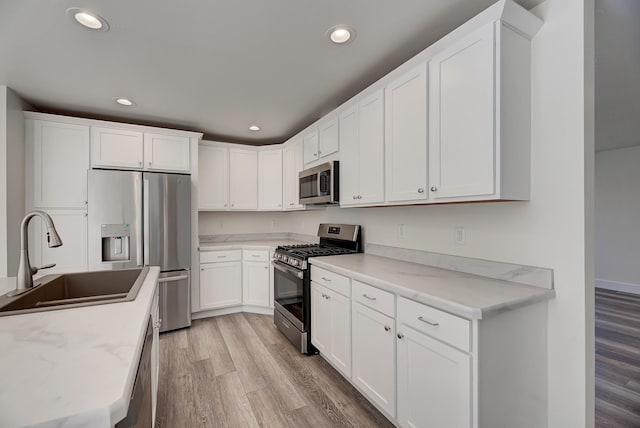 259 Stirling Loop, East Helena, MT 59635 - kitchen featuring stainless steel appliances, light wood-style flooring, recessed lighting, and white cabinets