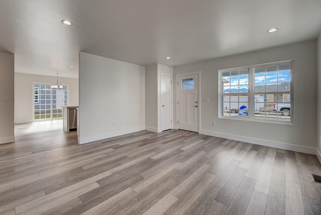 259 Stirling Loop, East Helena, MT 59635 - unfurnished living room featuring a chandelier, light wood-style floors, and recessed lighting
