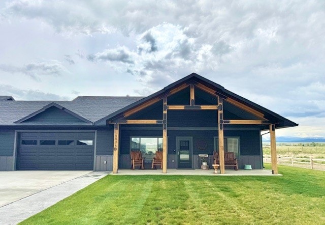 3975 Jaycee Ct Unit B, East Helena, MT 59635 - back of house featuring an attached garage, a porch, and driveway