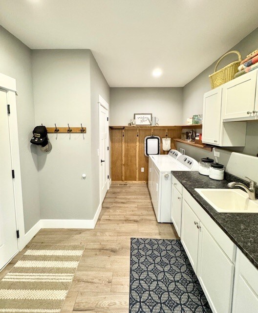 3975 Jaycee Ct Unit B, East Helena, MT 59635 - clothes washing area with washing machine and dryer, cabinet space, light wood-style floors, baseboards, and recessed lighting