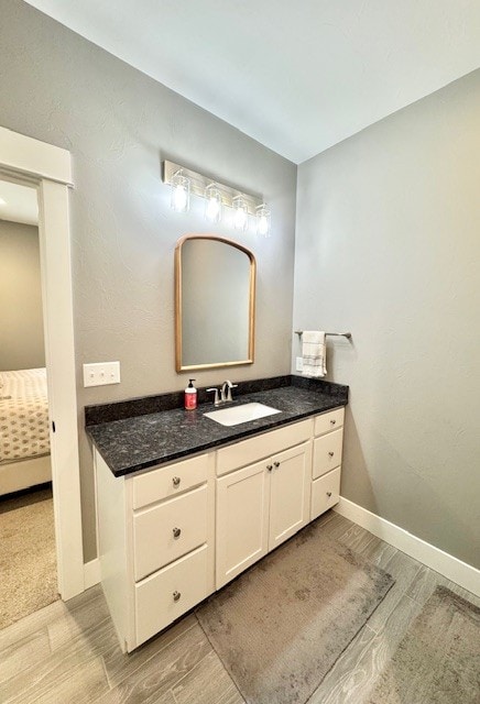 3975 Jaycee Ct Unit B, East Helena, MT 59635 - bathroom with wood finished floors, baseboards, vanity, and connected bathroom