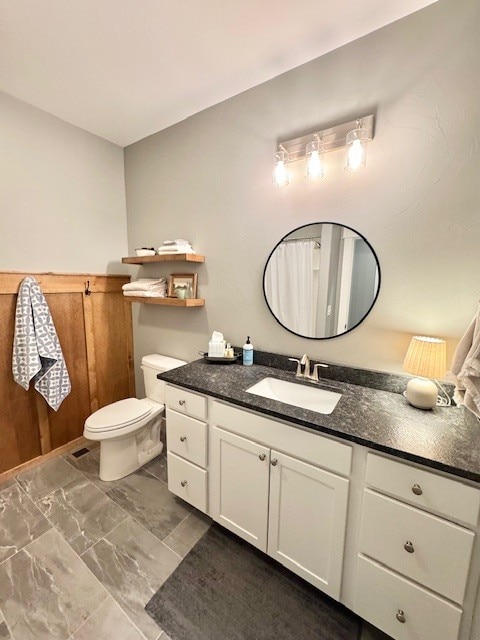 3975 Jaycee Ct Unit B, East Helena, MT 59635 - bathroom featuring marble look tiles, toilet, and vanity
