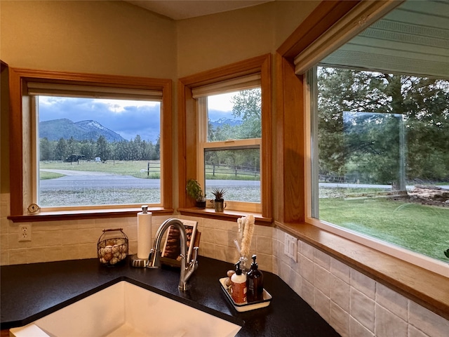 interior space with a sink, plenty of natural light, and a mountain view