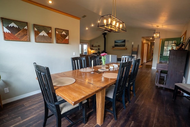 dining space featuring wood finished floors, baseboards, lofted ceiling, a chandelier, and recessed lighting