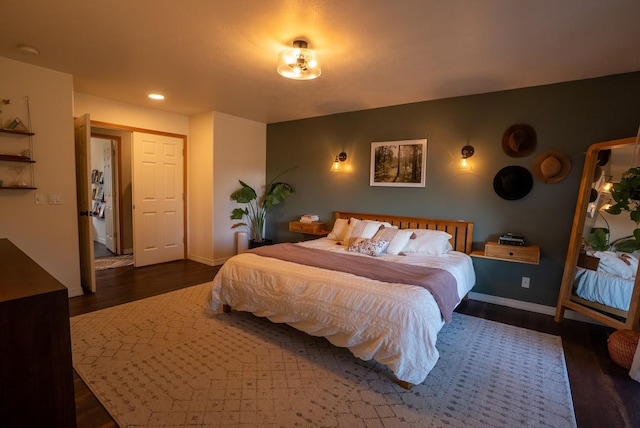 bedroom featuring wood finished floors, baseboards, and recessed lighting
