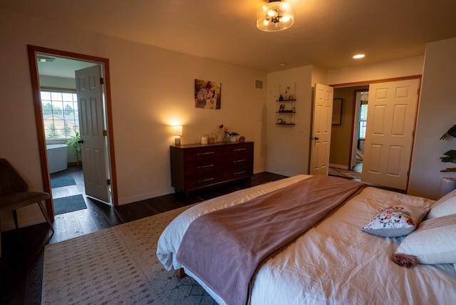 bedroom featuring dark wood-style flooring and baseboards