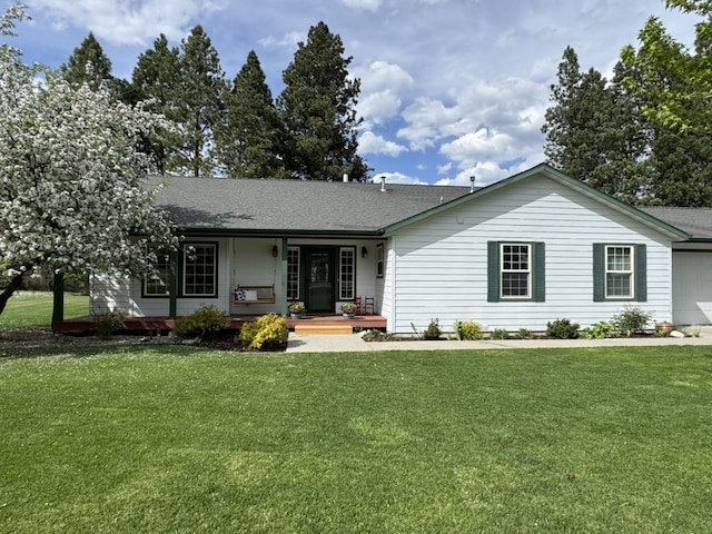 single story home featuring covered porch, a front yard, roof with shingles, and a garage